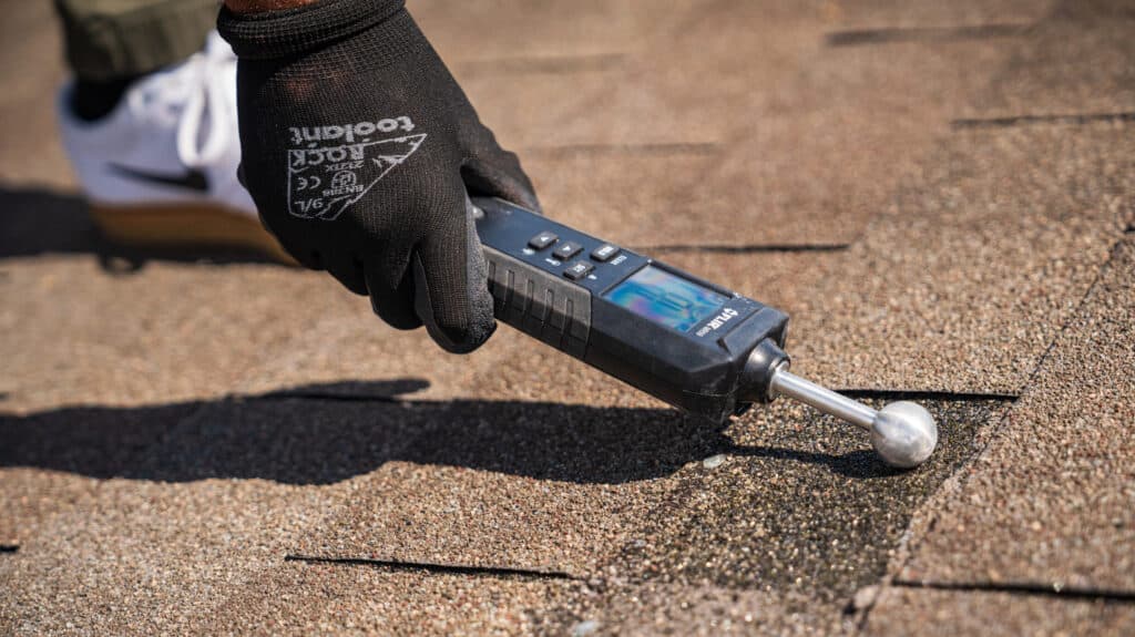 Austin Roofers inspector performing a free moisture test on an Austin roof